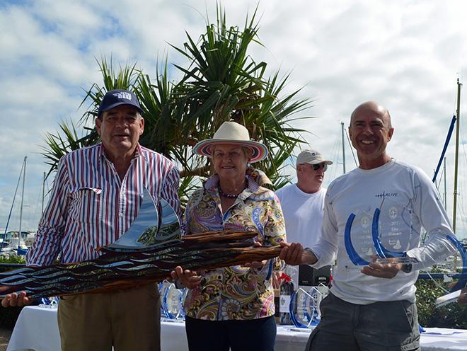 Duncan Hine Alive skipper (3rd from right) collects the line honours trophy from Richard and Libby Wilson © Keppel Bay Marina